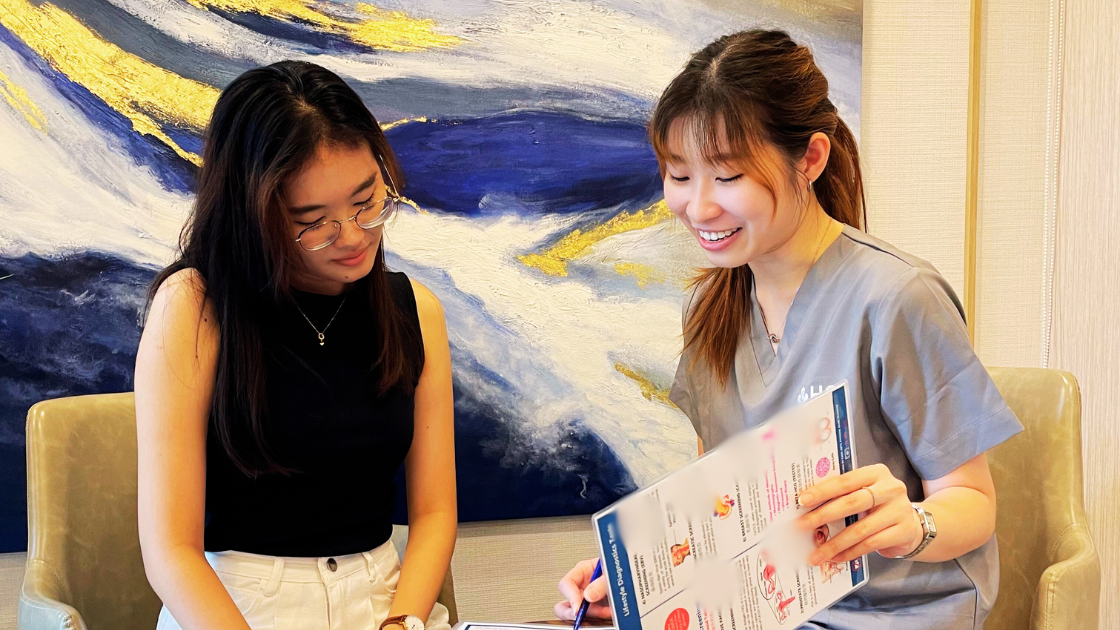 A nurse interacting with a patient in a clean, modern healthcare setting.