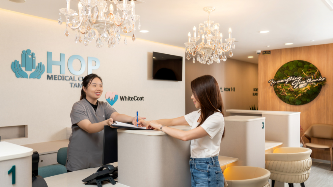 A serene clinic in Singapore with individuals undergoing health screenings, featuring modern medical equipment and a calm atmosphere with natural light.