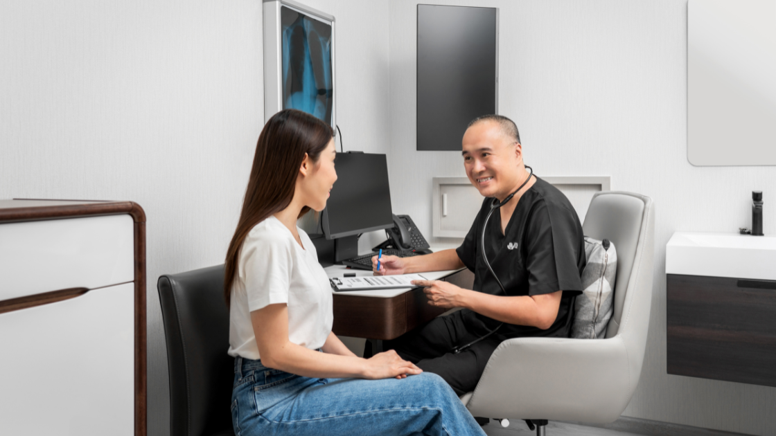 A doctor consulting with a client at HOP Medical Centre, highlighting comprehensive health screening SG services.