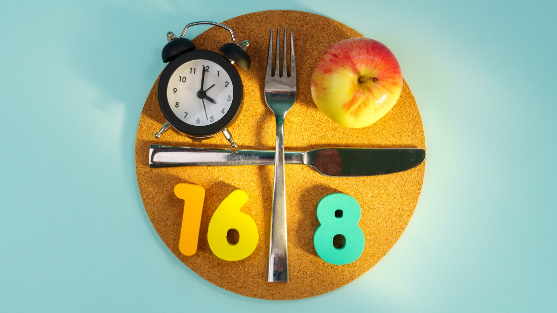Plate with a clock and an apple, representing intermittent fasting and its connection to heart health and health screening SG services.
