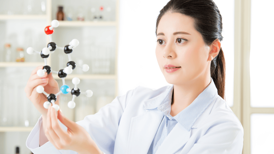 A doctor holding a prop longevity molecule, representing advancements in preventive healthcare and health screening SG.