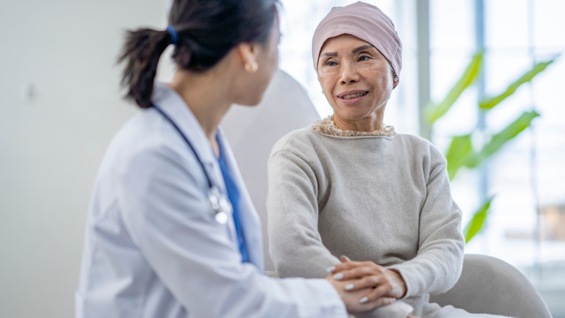 Lady with cancer speaking to a nurse during consultation at a health screening SG center