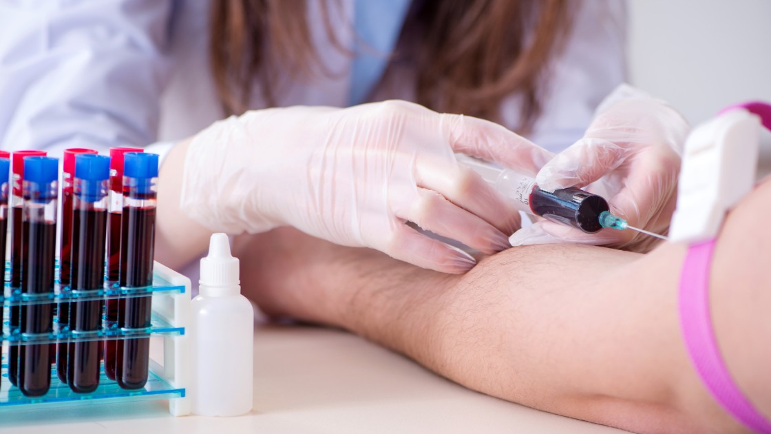 Nurse drawing blood from a patient during health screening SG at a medical clinic in Singapore