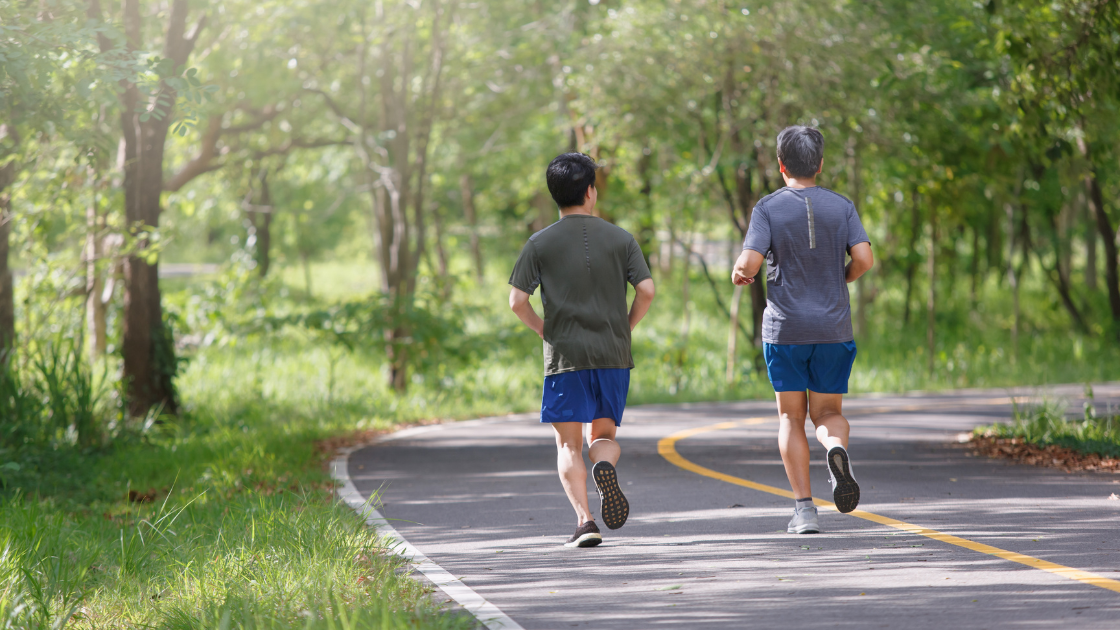 Two Singaporean men jogging in the park promoting fitness and health screening SG