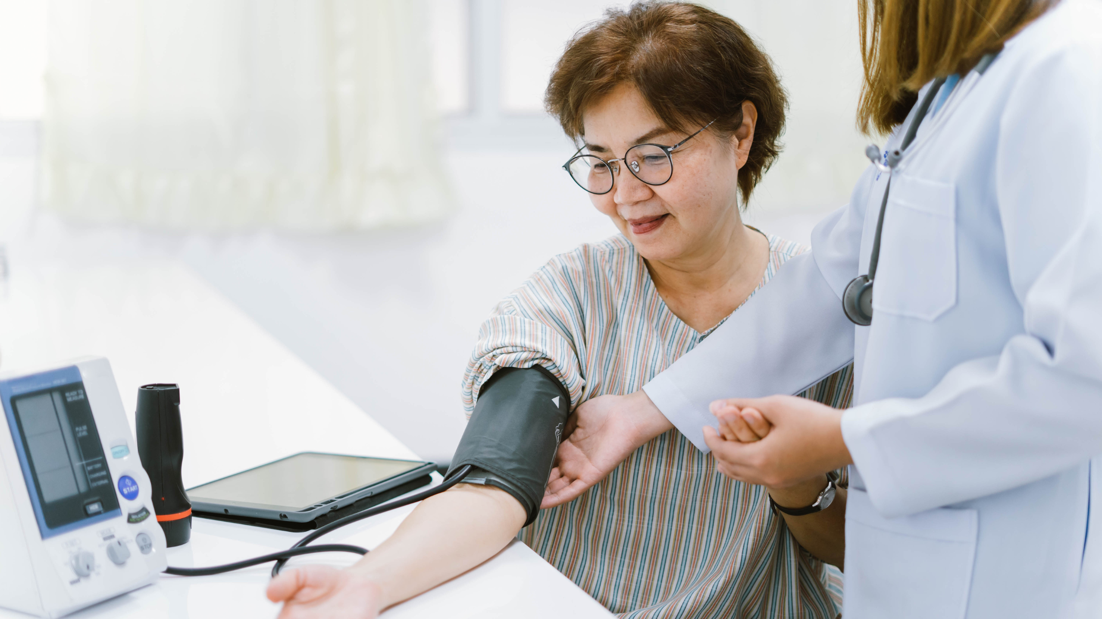 Lady getting blood pressure check by nurse at HOP Singapore during health screening SG