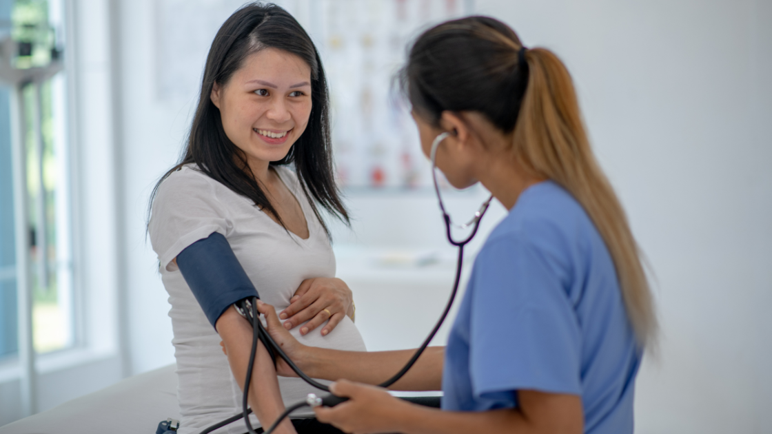 Lady having her blood pressure measured by HOP Singapore staff during a professional health screening session