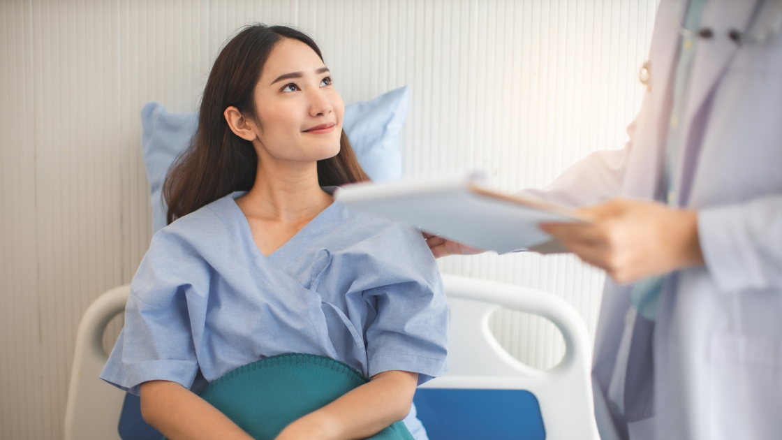 Female patient receiving a health screening SG examination from a doctor in a clinic
