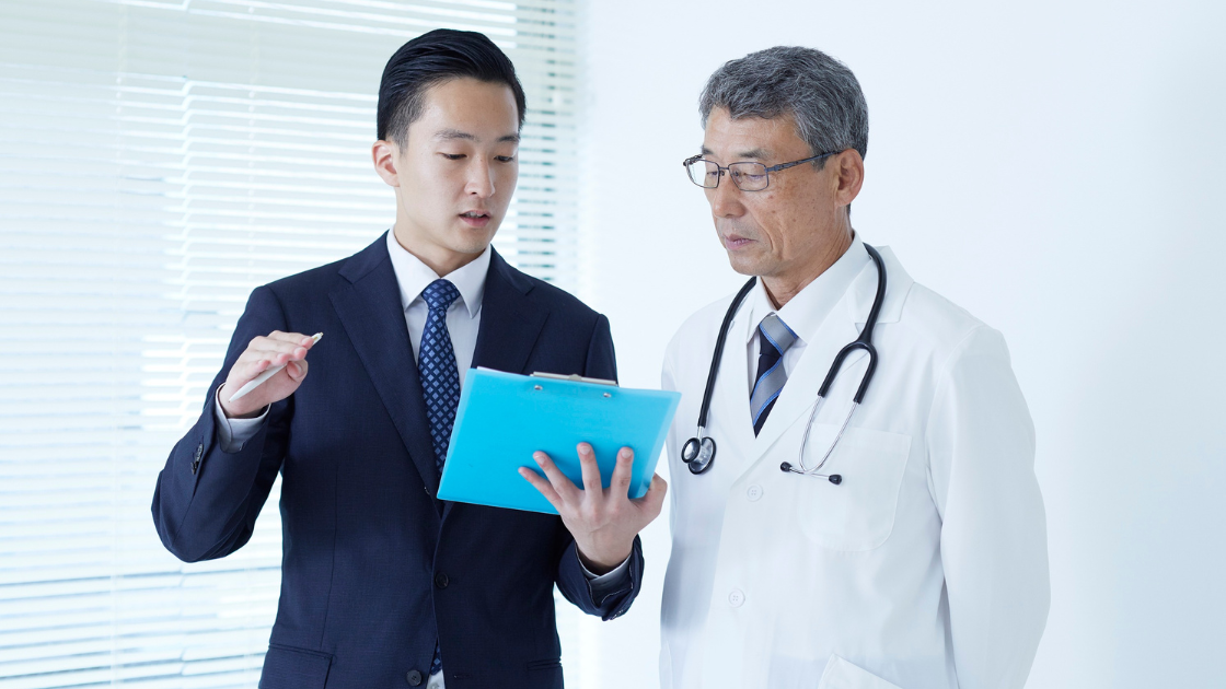 A man consulting a HOP Singapore doctor about health screening SG packages and options