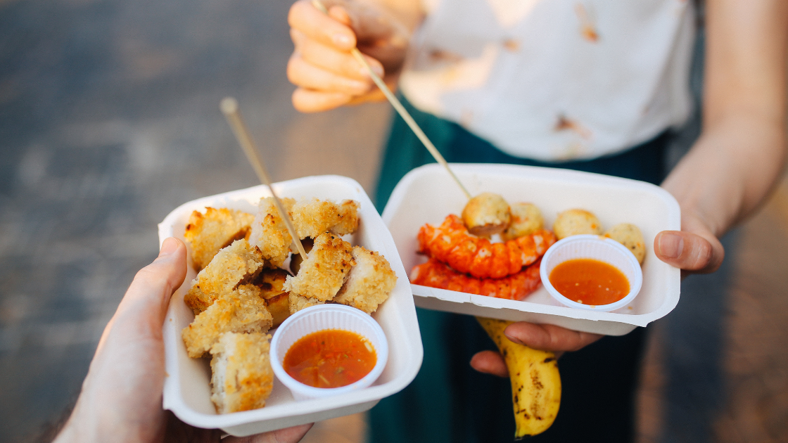 Popular Singapore street food dishes at hawker centre highlighting cholesterol considerations for health screening