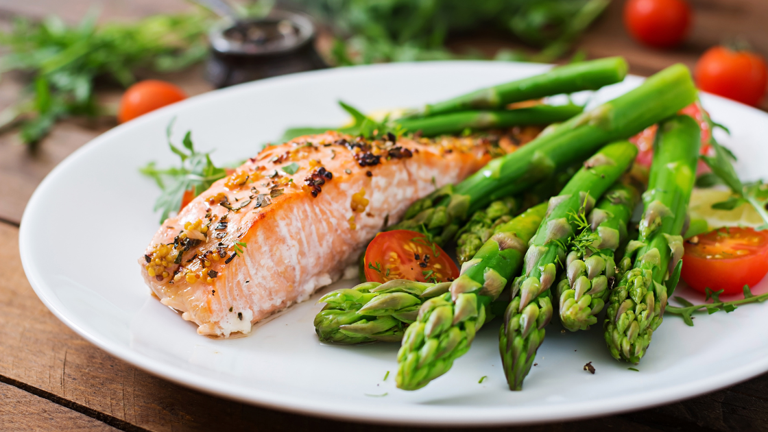 Perfectly baked salmon fillet on white plate with Asian teriyaki glaze, garnished with spring onions and sesame seeds, Singapore style healthy recipe