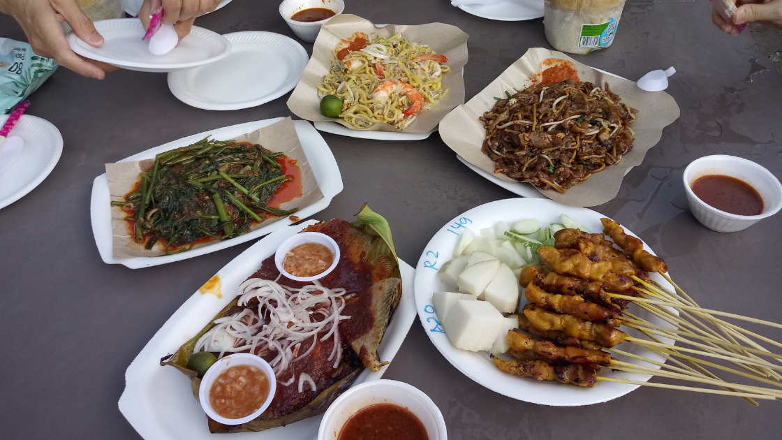 Colorful spread of popular Singapore hawker dishes on a table