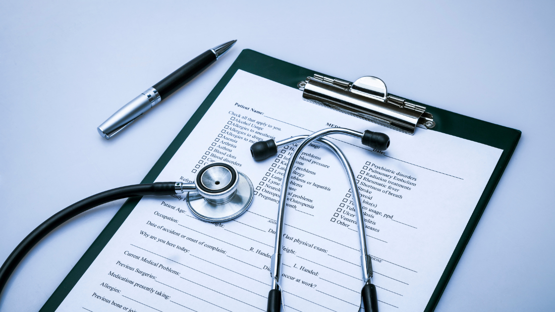 Medical stethoscope pen and health screening reports on desk representing comprehensive health checkup packages in Singapore