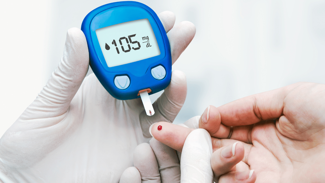 Healthcare professional conducting finger prick blood glucose test for diabetes screening in Singapore medical clinic