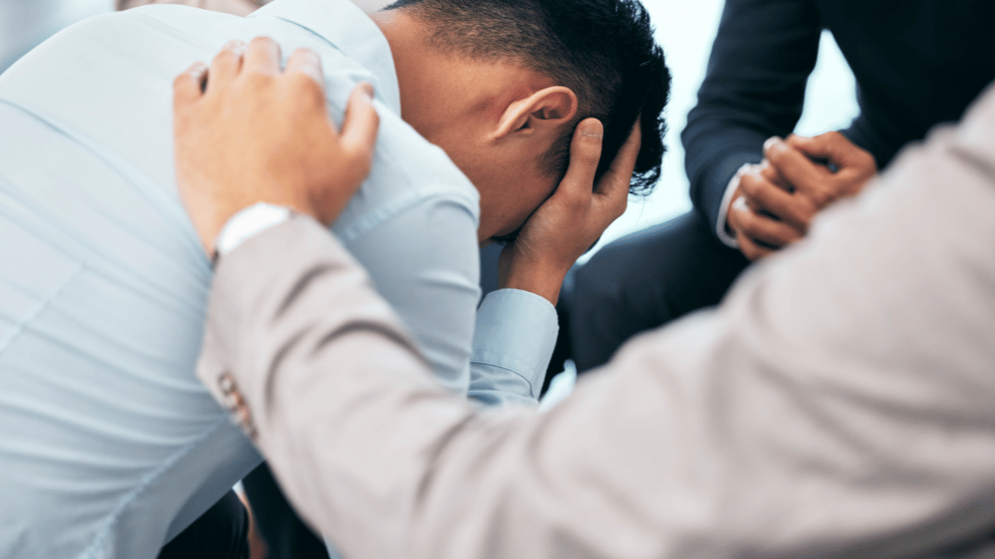 Stressed male executive experiencing mental health breakdown at workplace in Singapore business environment