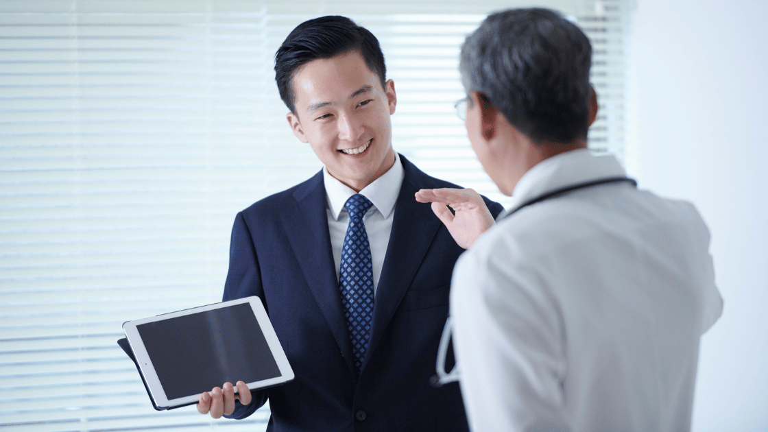 Male Singapore executive consulting with doctor about premium executive health singapore screening options at modern medical facility