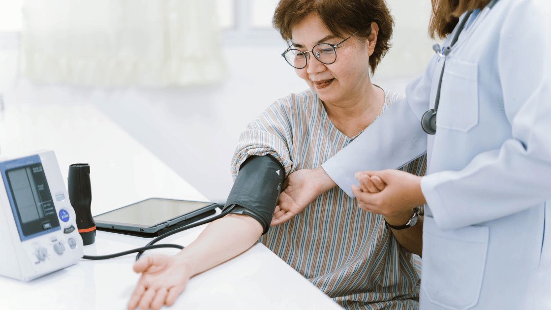 Elderly lady getting blood pressure checked by healthcare professional at HOP Medical Centre Singapore during health screening