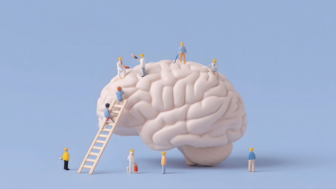 Miniature workers surrounding a brain model symbolizing corporate brain health nutrition and preventive workplace wellness strategy