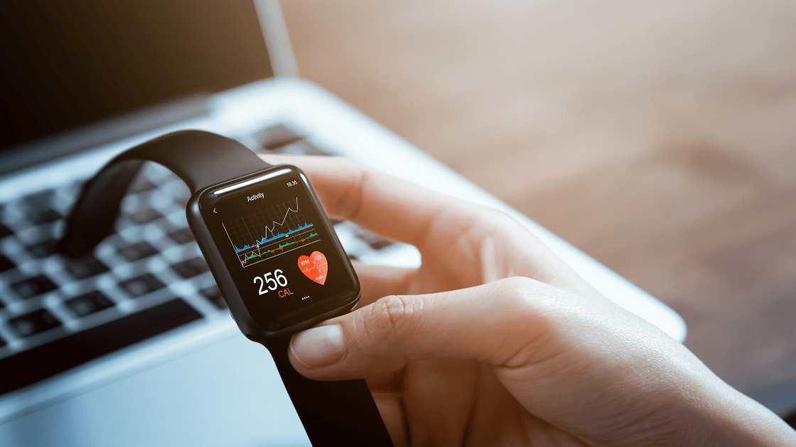 Close-up of a person's wrist wearing a smartwatch displaying health metrics and fitness tracking data for wearable health trackers in Singapore