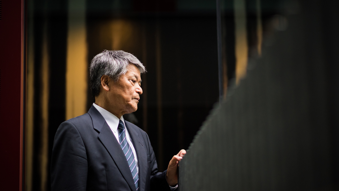 Senior male executive in business suit representing Singapore's aging workforce requiring comprehensive health screening programmes