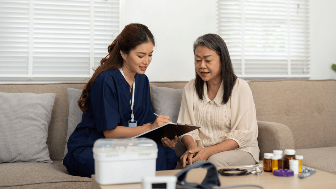 Healthcare nurse consulting female patient about symptoms of serious health conditions during medical evaluation