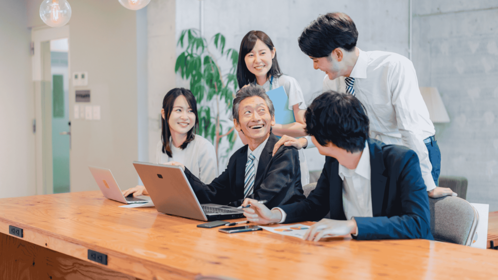 Singapore office colleagues discussing corporate health screening benefits and cancer prevention programs at workplace meeting