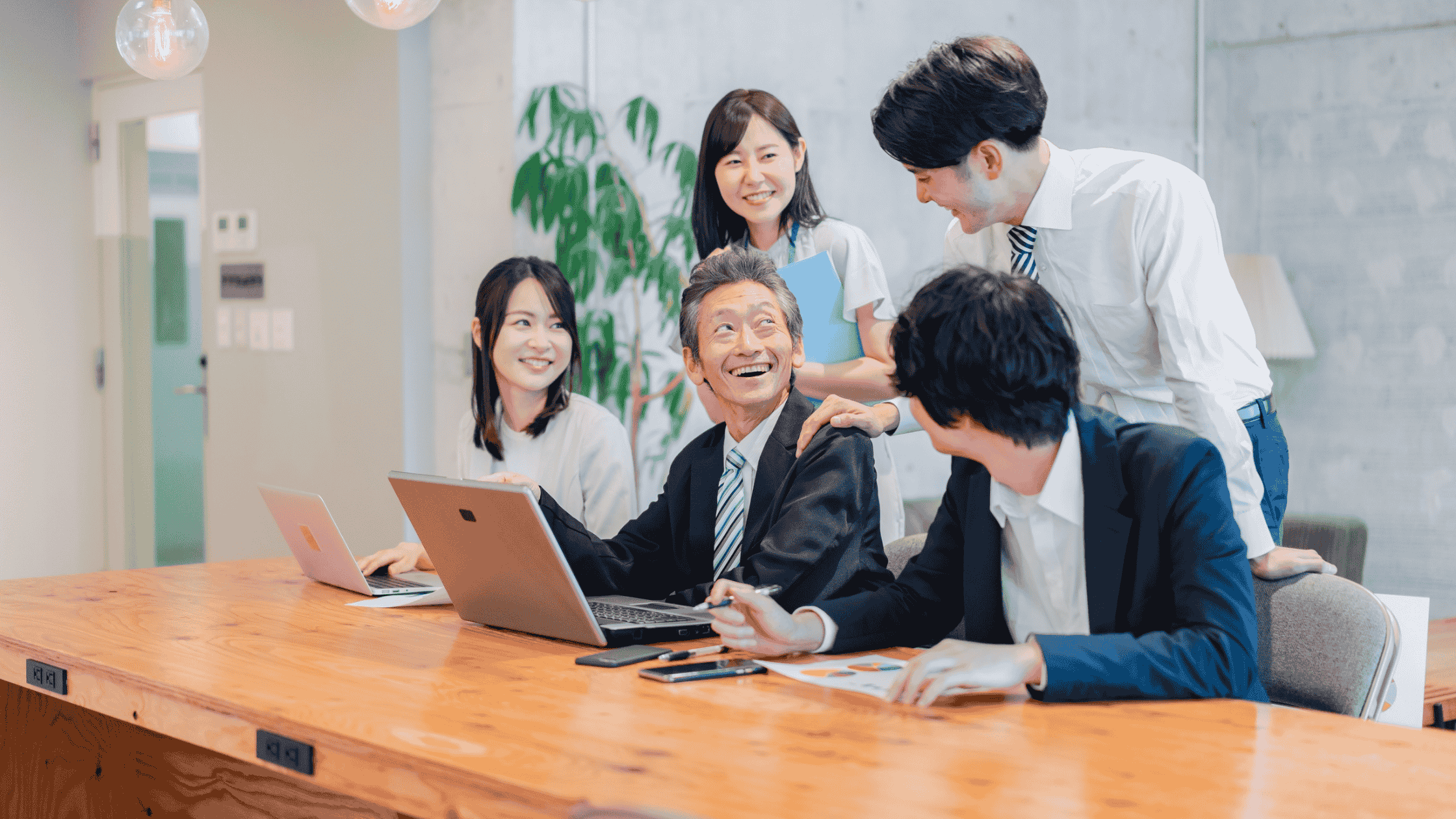 Singapore office colleagues discussing corporate health screening benefits and cancer prevention programs at workplace meeting