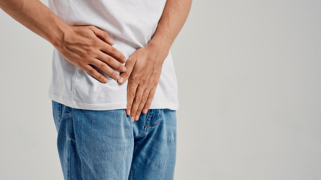 Man holding groin area representing erectile dysfunction symptoms in Singapore
