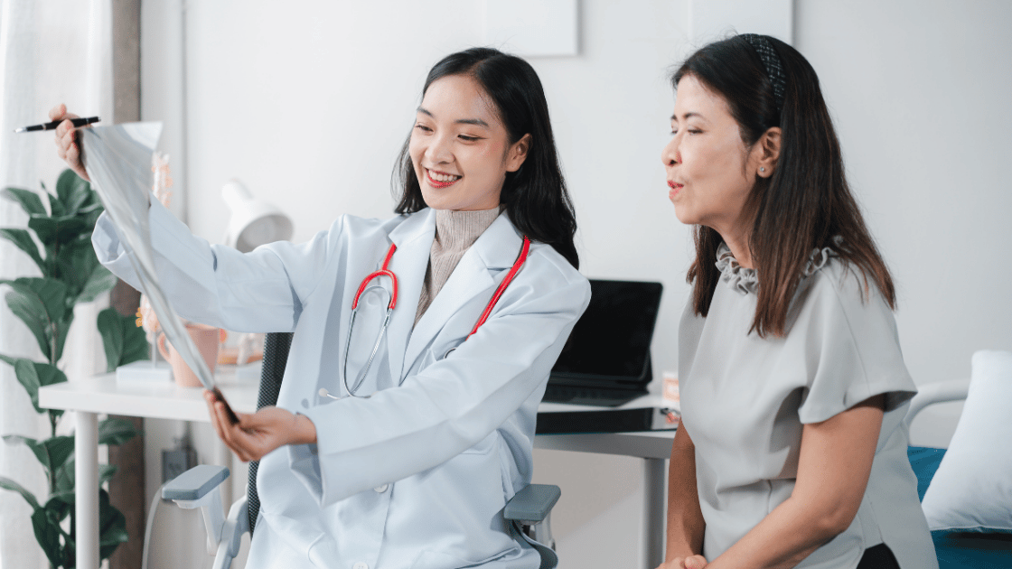 Doctor showing a female patient her hepatitis B screening results at a clinic in Singapore