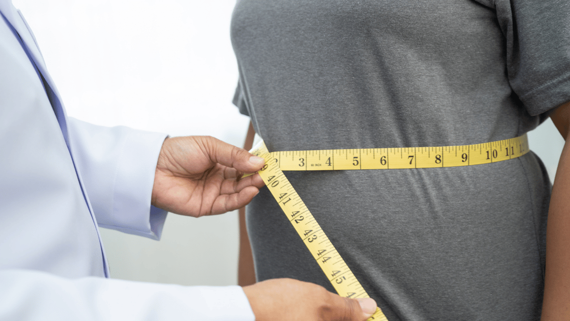 Doctor measuring a patient's waist during a GLP-1 consultation at HOP Medical Centre